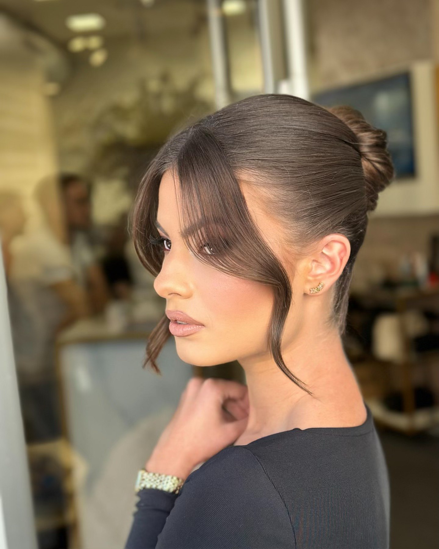 Sleek Low Bun With Face Framing Wisps