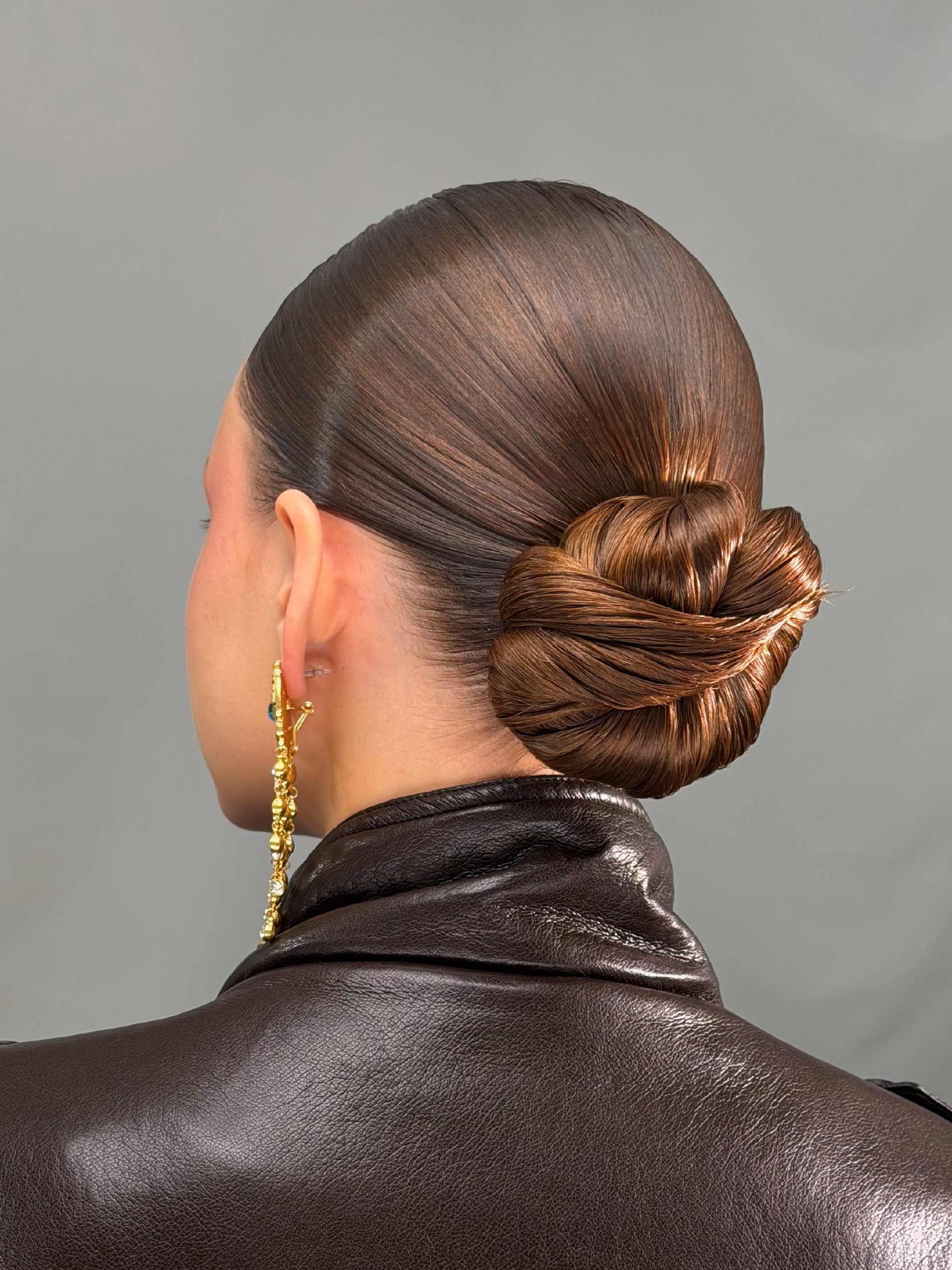 Sleek Twisted Low Bun With Caramel Balayage