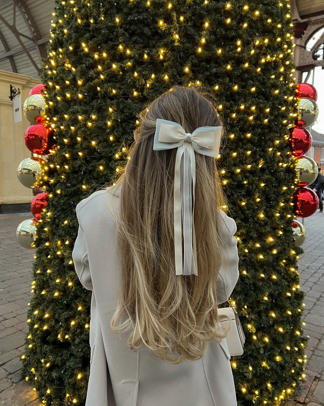 Soft Blonde Waves With Delicate Bow Accent