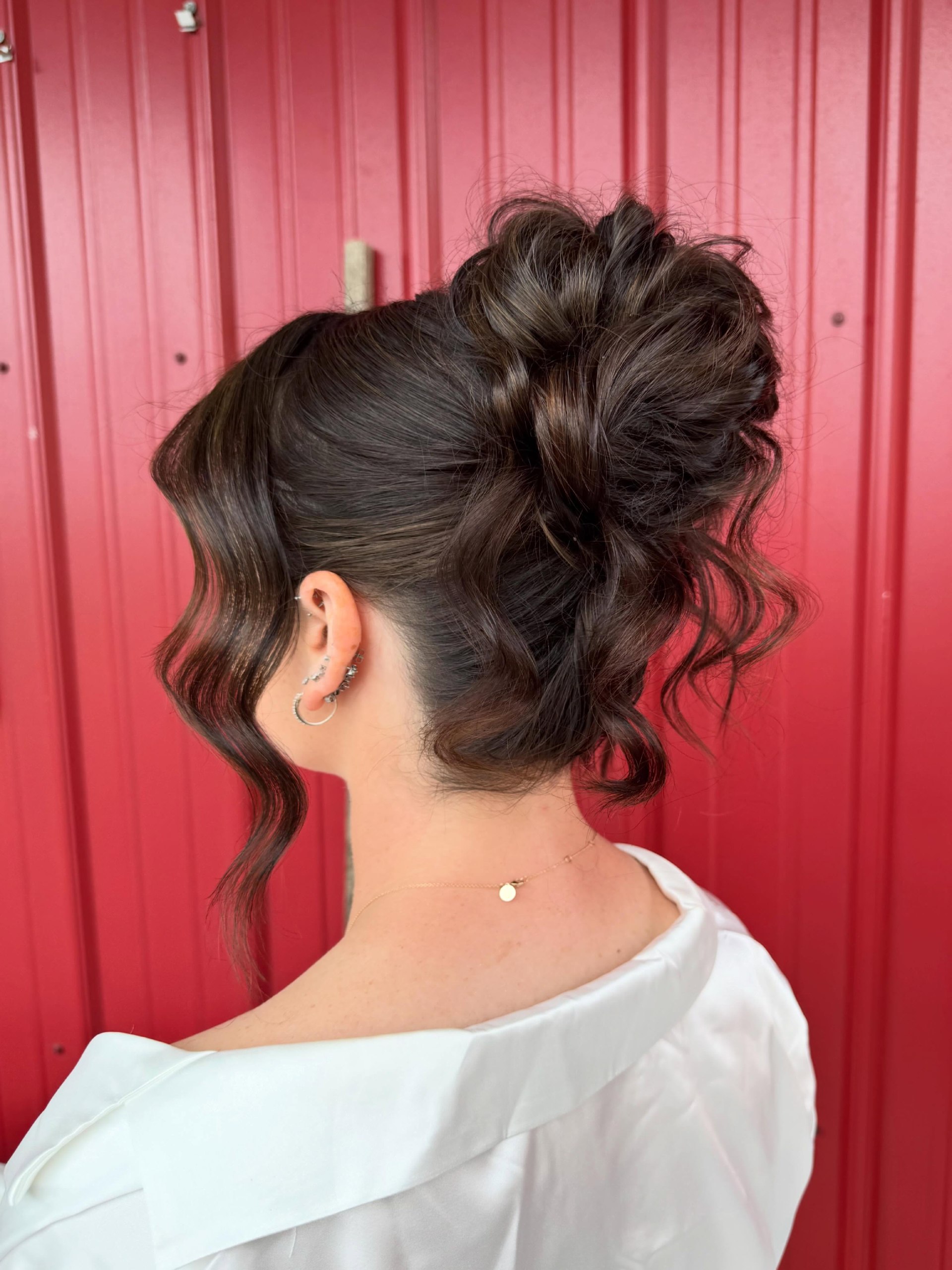 Soft Waves High Bun With Face Framing Tendrils