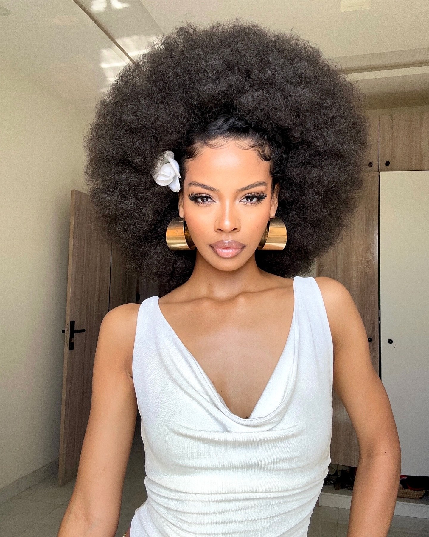 Voluminous Afro With Defined Edges And Flower Accent