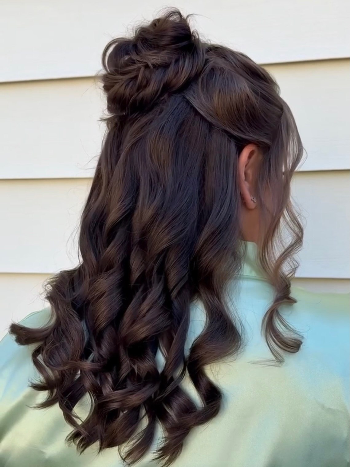 Voluminous Half-Up Curls With A Messy Top Knot