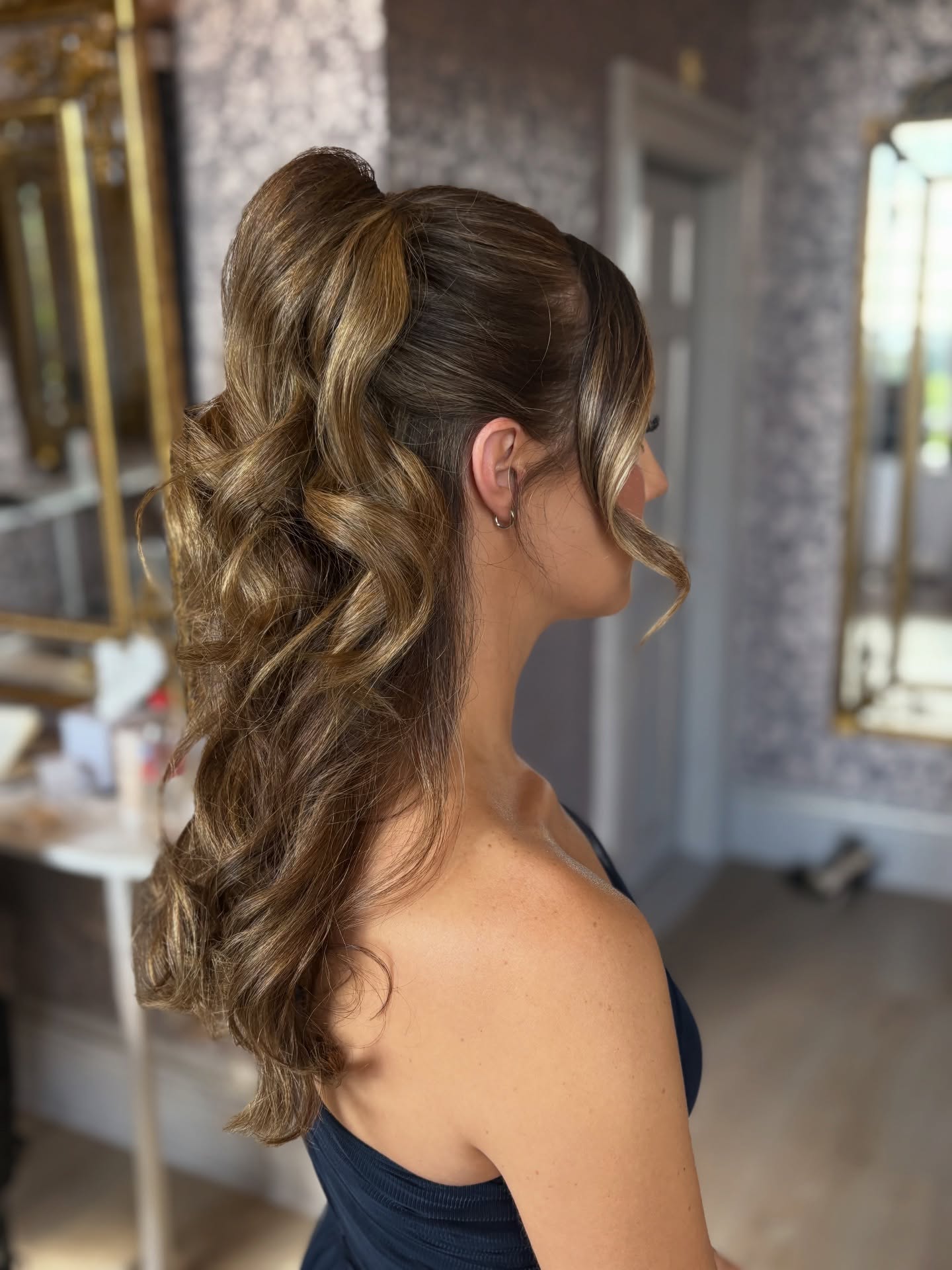 Voluminous High Ponytail With Soft Curls