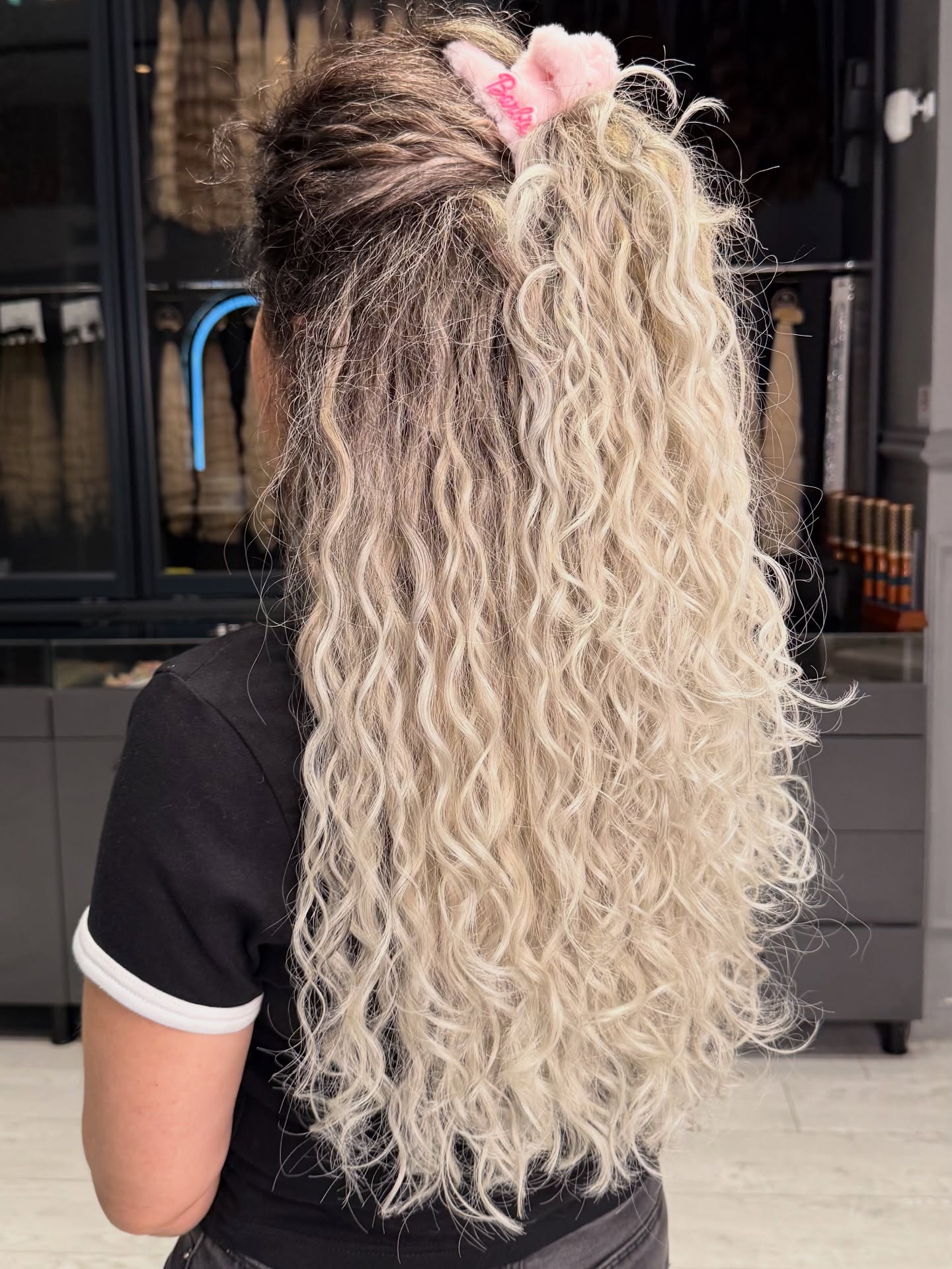 Voluminous Honey Blonde Curls With A Deep Side Part