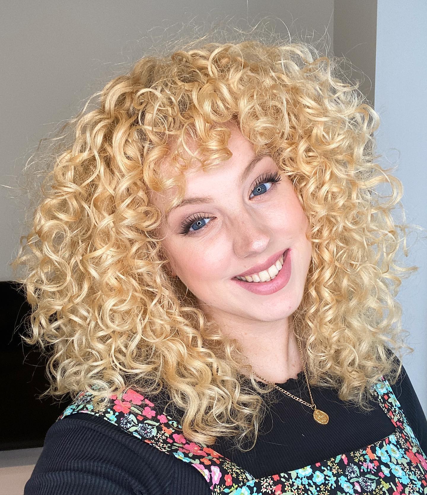 Voluminous Honey Blonde Curls With Face-Framing Bangs