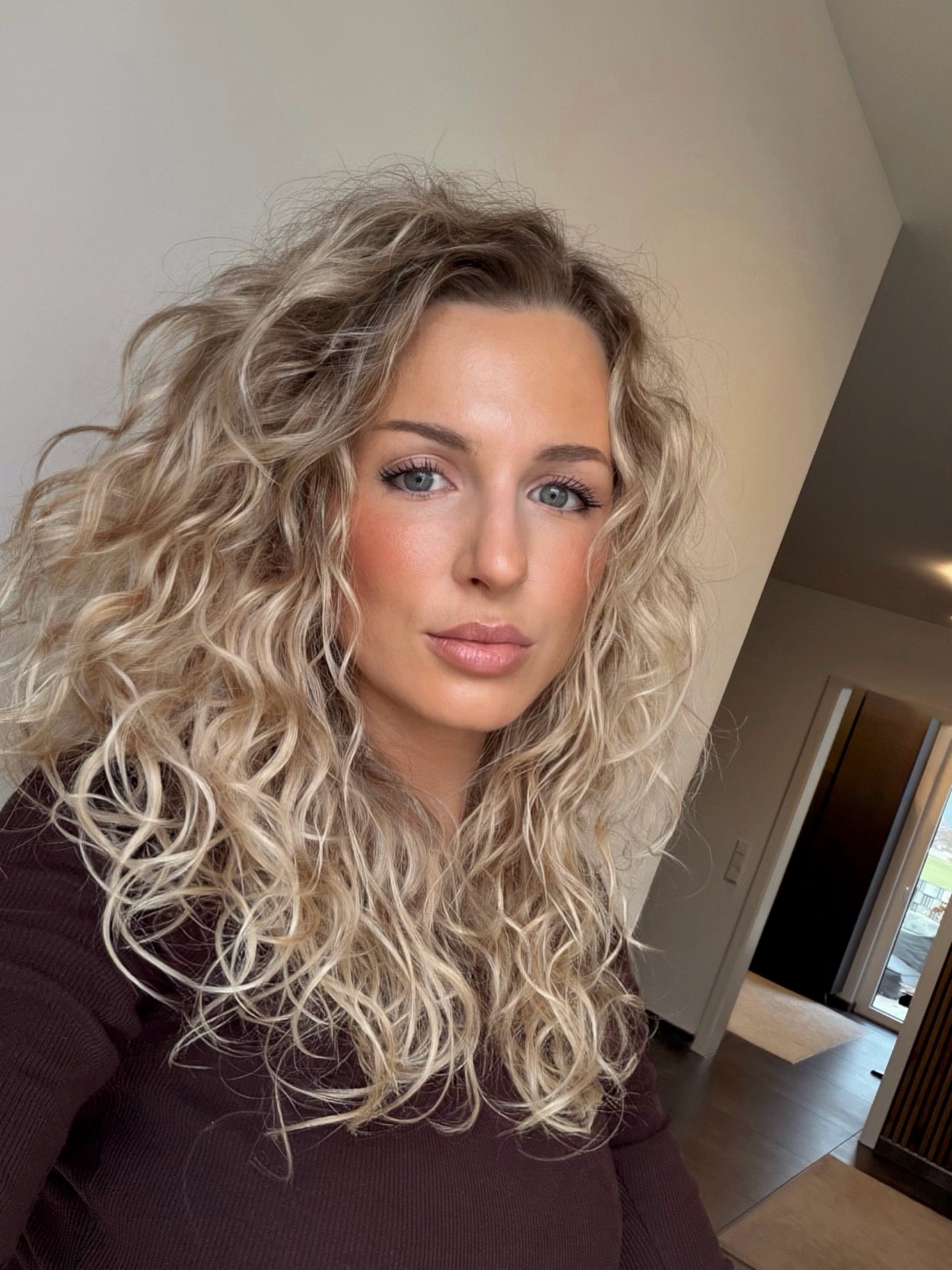 Voluminous Honey Blonde Curls With Face-Framing Layers
