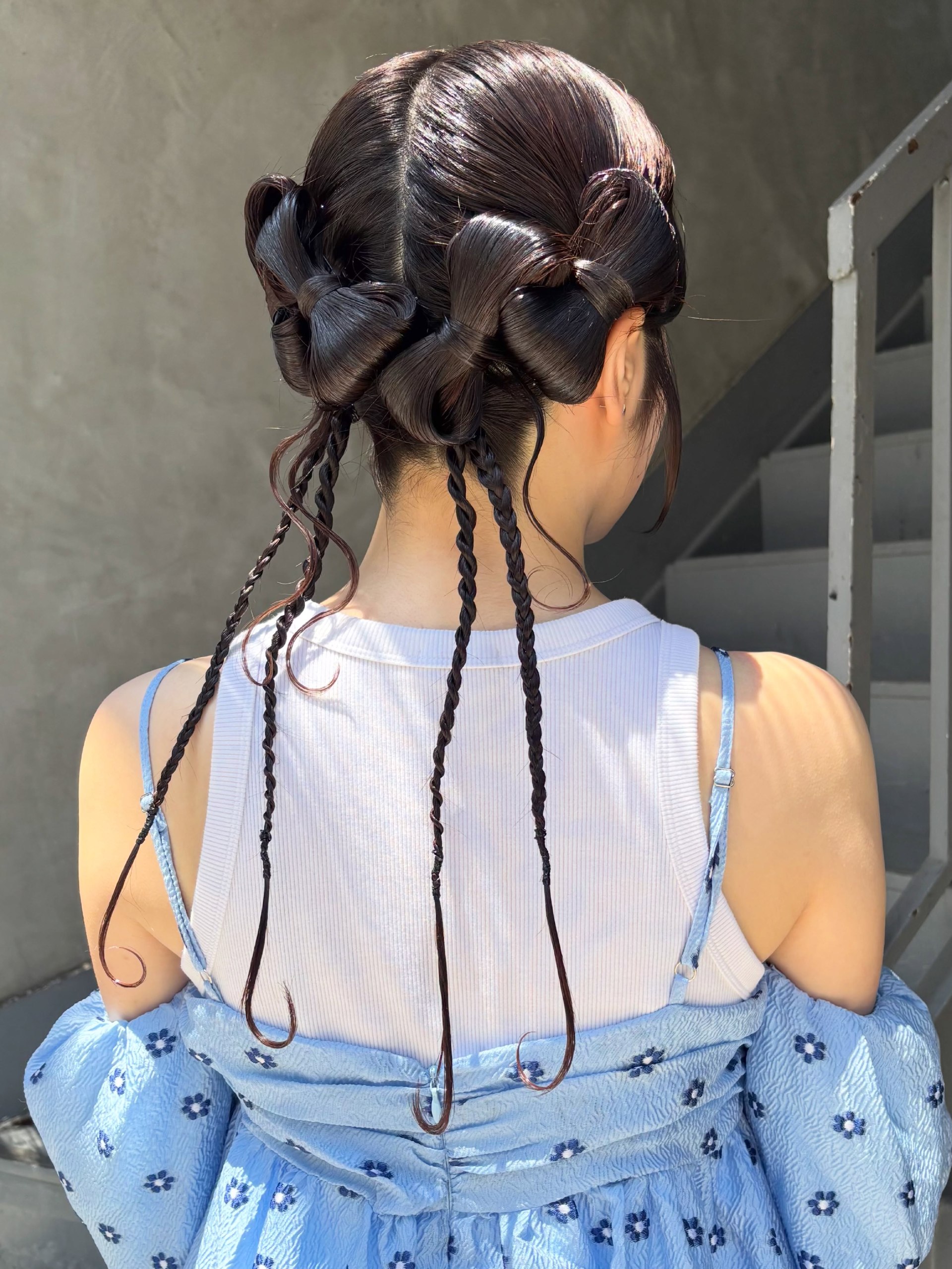 Whimsical Braided Space Buns With Dangling Tendrils