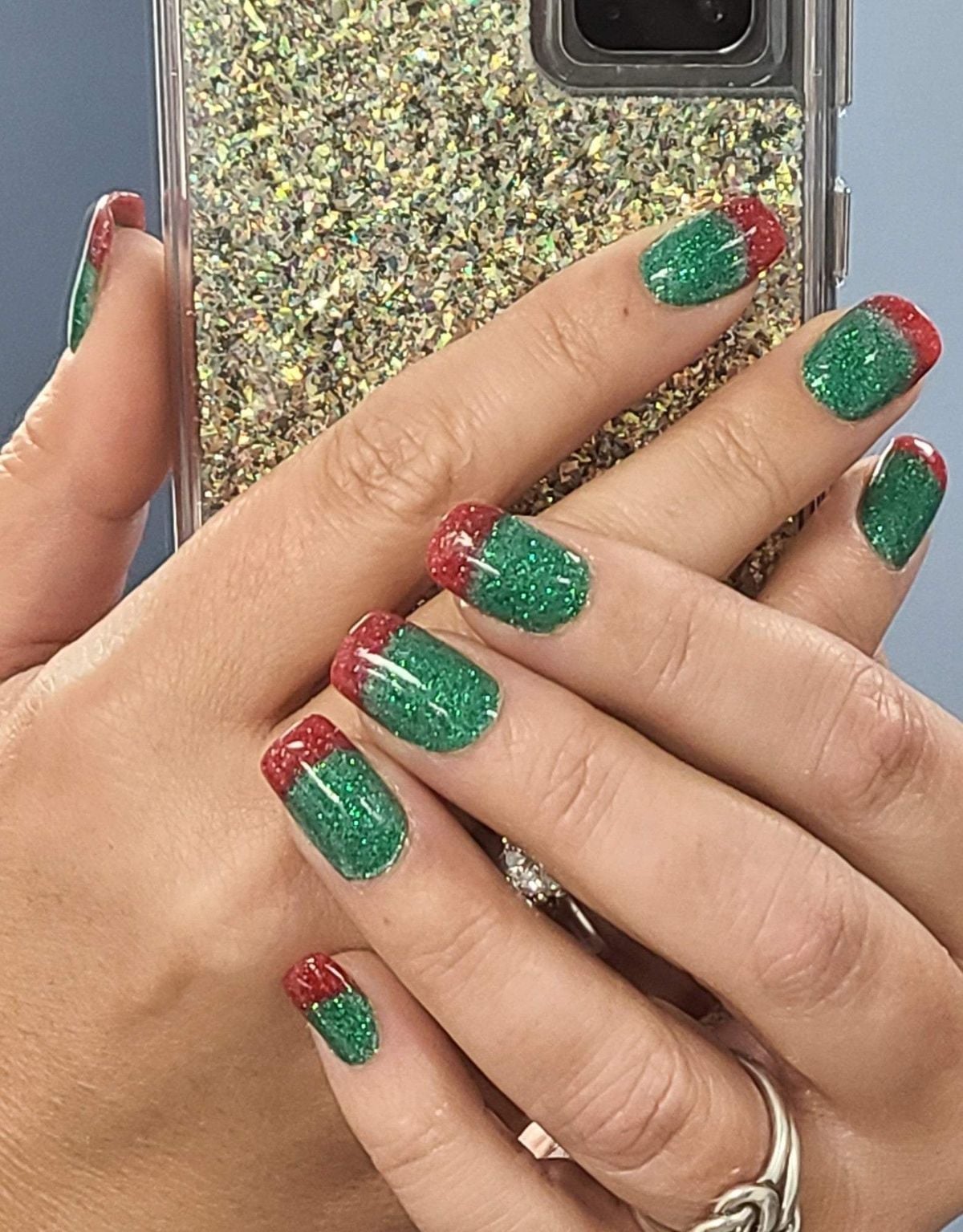 Green Glitter Red French Tip Short Almond Nails, Close-Up Take Green Glitter Red French Tip Short Almond Nails, Close-Up Take — Christmas Dip Nails