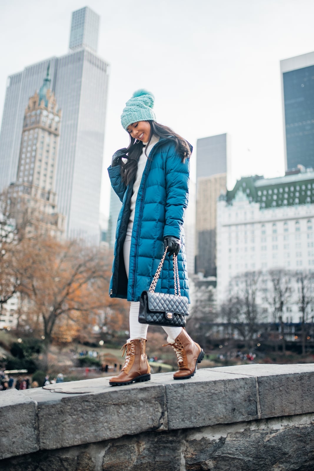 Teal long puffer coat with white sweater and slim pants — Cold Weather Outfits