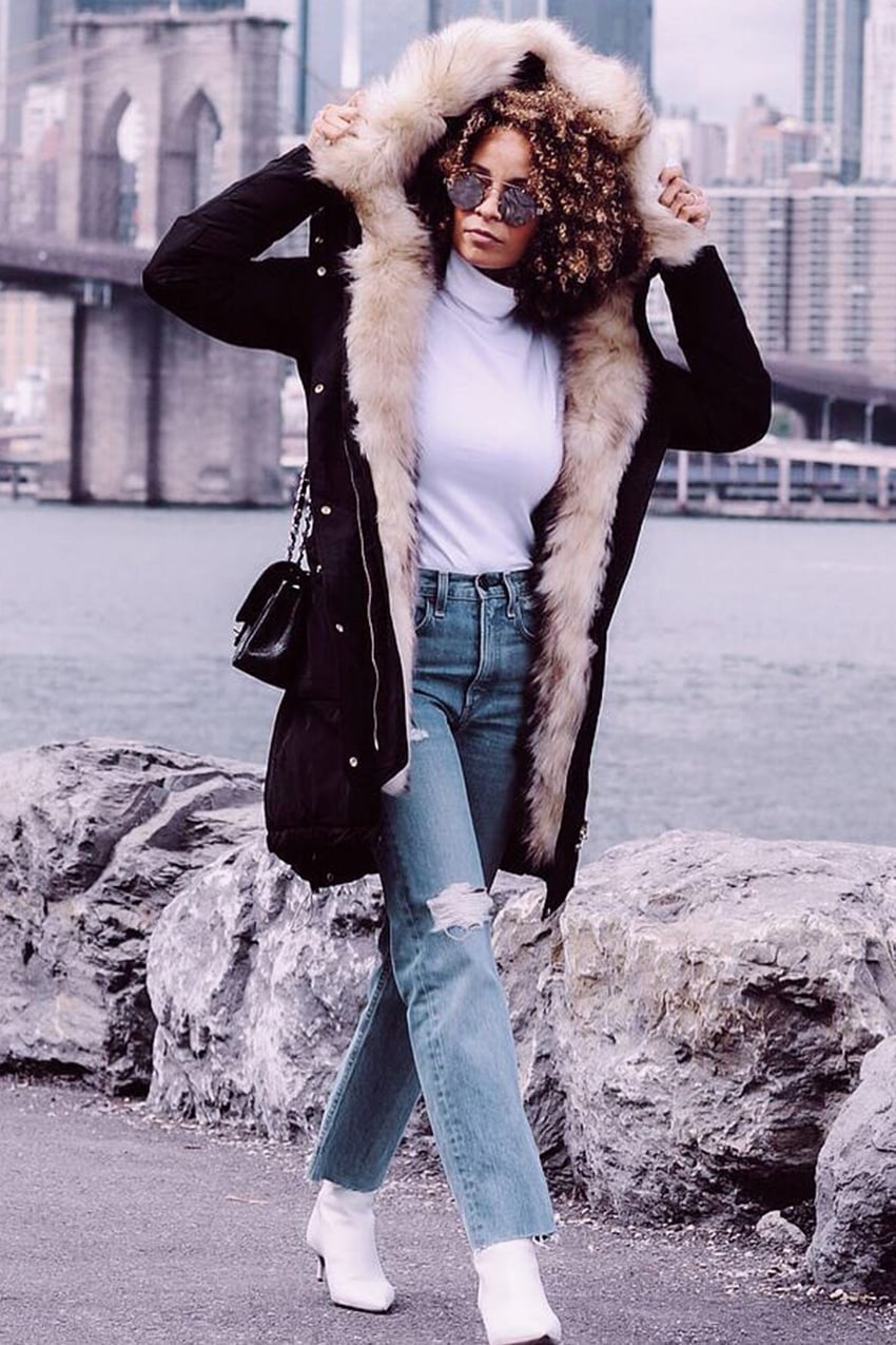 Black fur-lined parka with turtleneck and ripped jeans — Cold Weather Outfits
