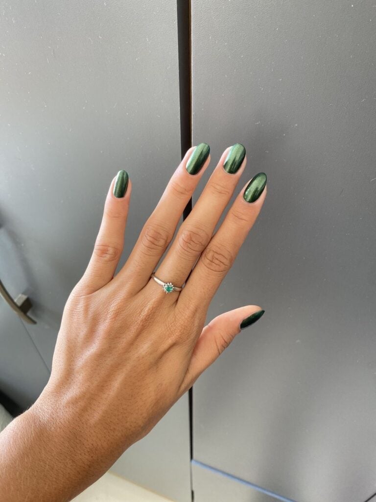 Short Almond Shimmer Green with Silver Stars, Close-Up Take — Dark Green Christmas Nails