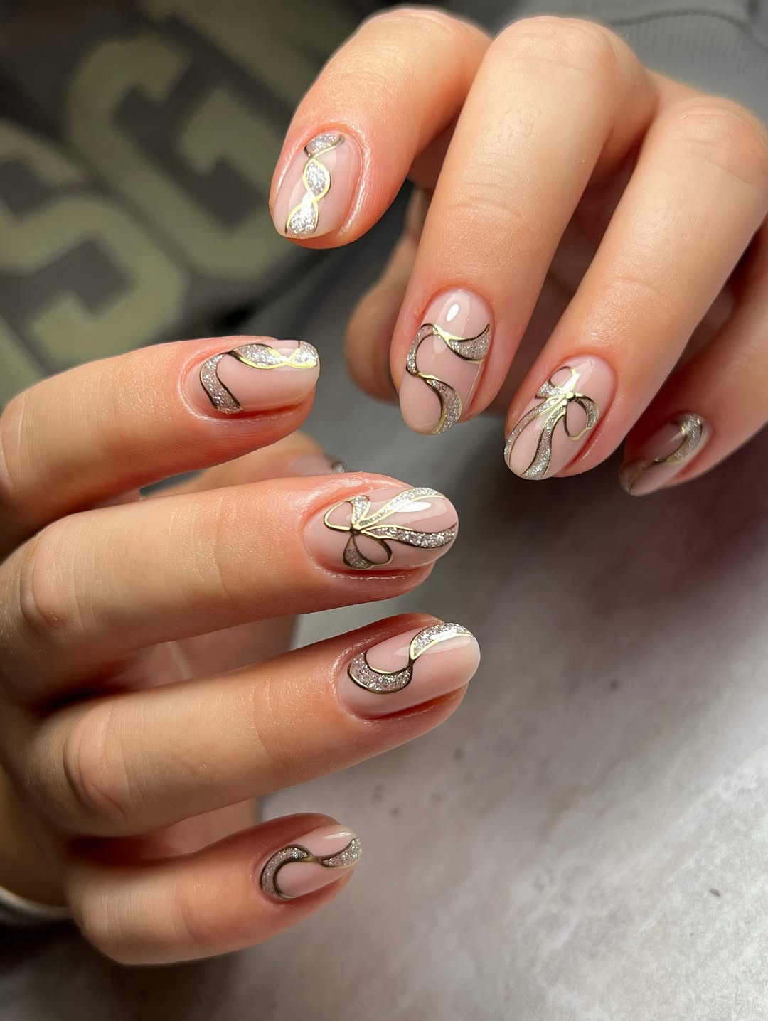 Elegant Gold Ribbon Bow Almond Nails