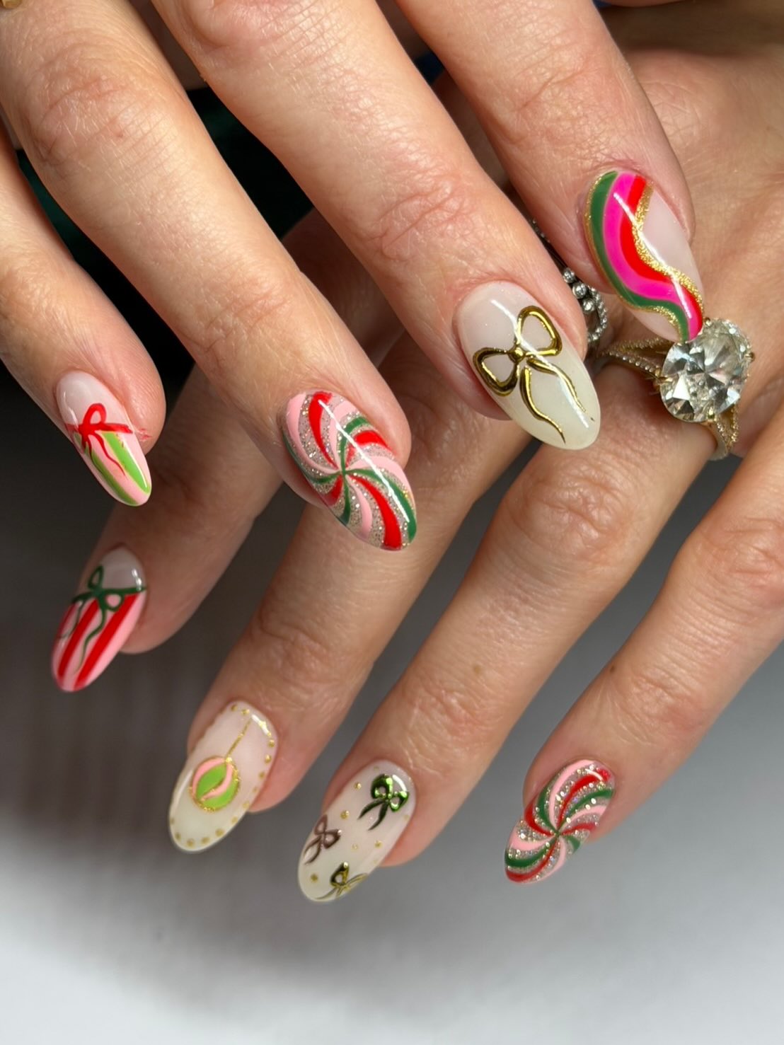 Festive Christmas Bow and Candy Cane Almond Nails