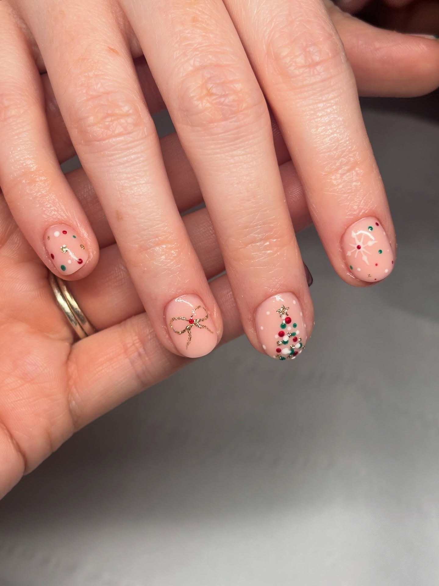 Festive Nude Nails With Tiny Christmas Art