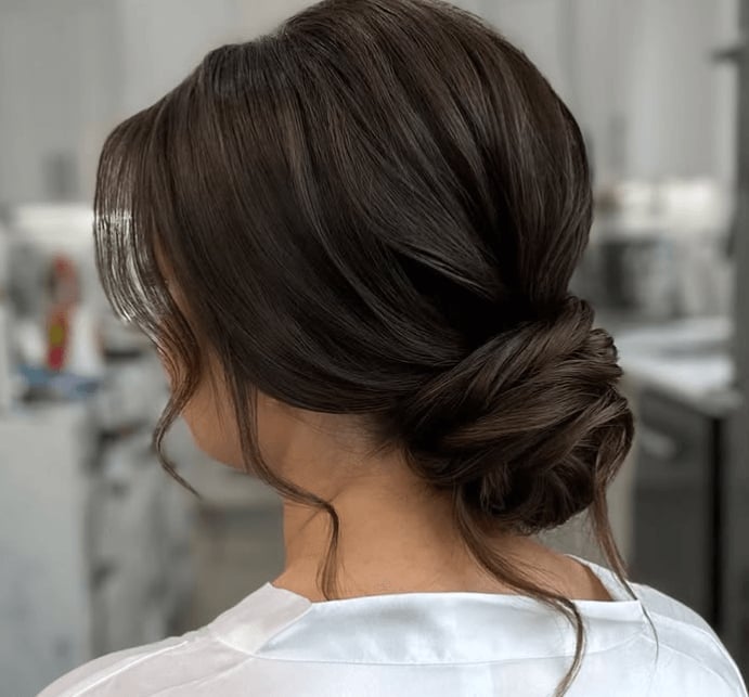 Soft Dark Brown Low Bun With Face-Framing Pieces — New Years Eve Hairstyles