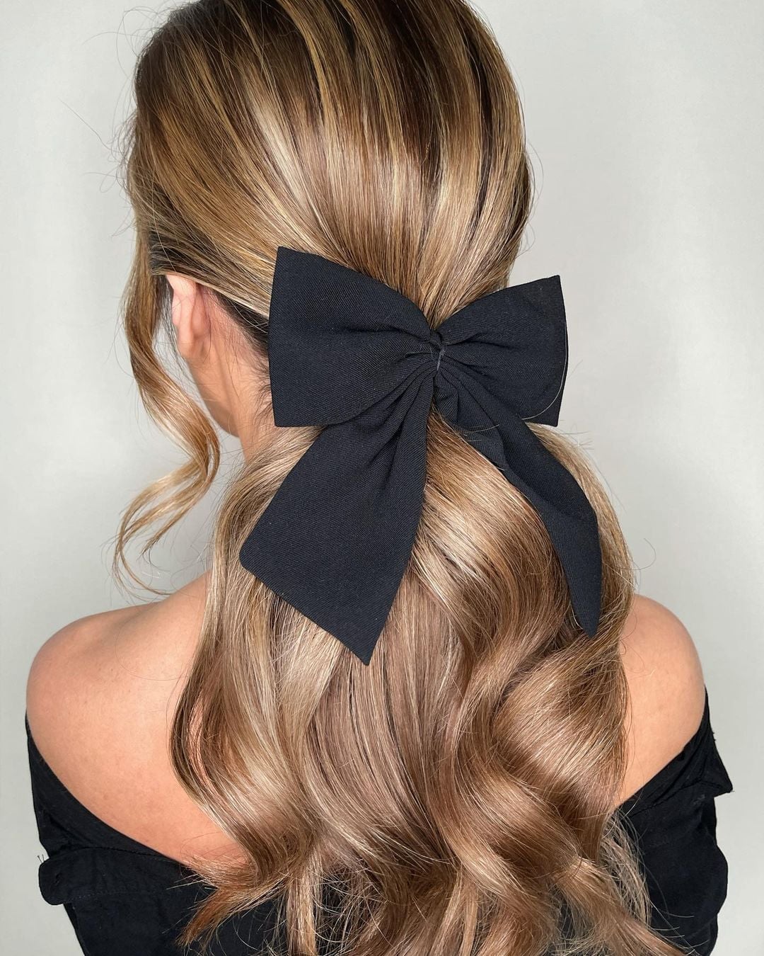 Ash Blonde Half Up Half Down With Black Bow — New Years Eve Hairstyles