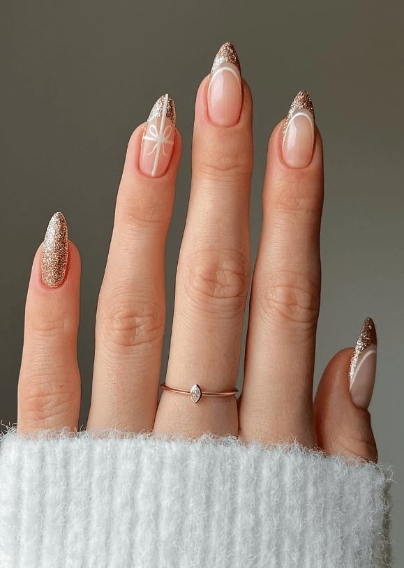 Long Almond Nude With Gold Glitter Bows Long Almond Nude With Gold Glitter Bows — Nude Christmas Nails