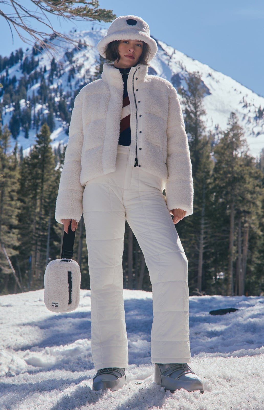 White Teddy Puffer Jacket Over Striped Sweater and Quilted Pants — Ski Outfits for Women