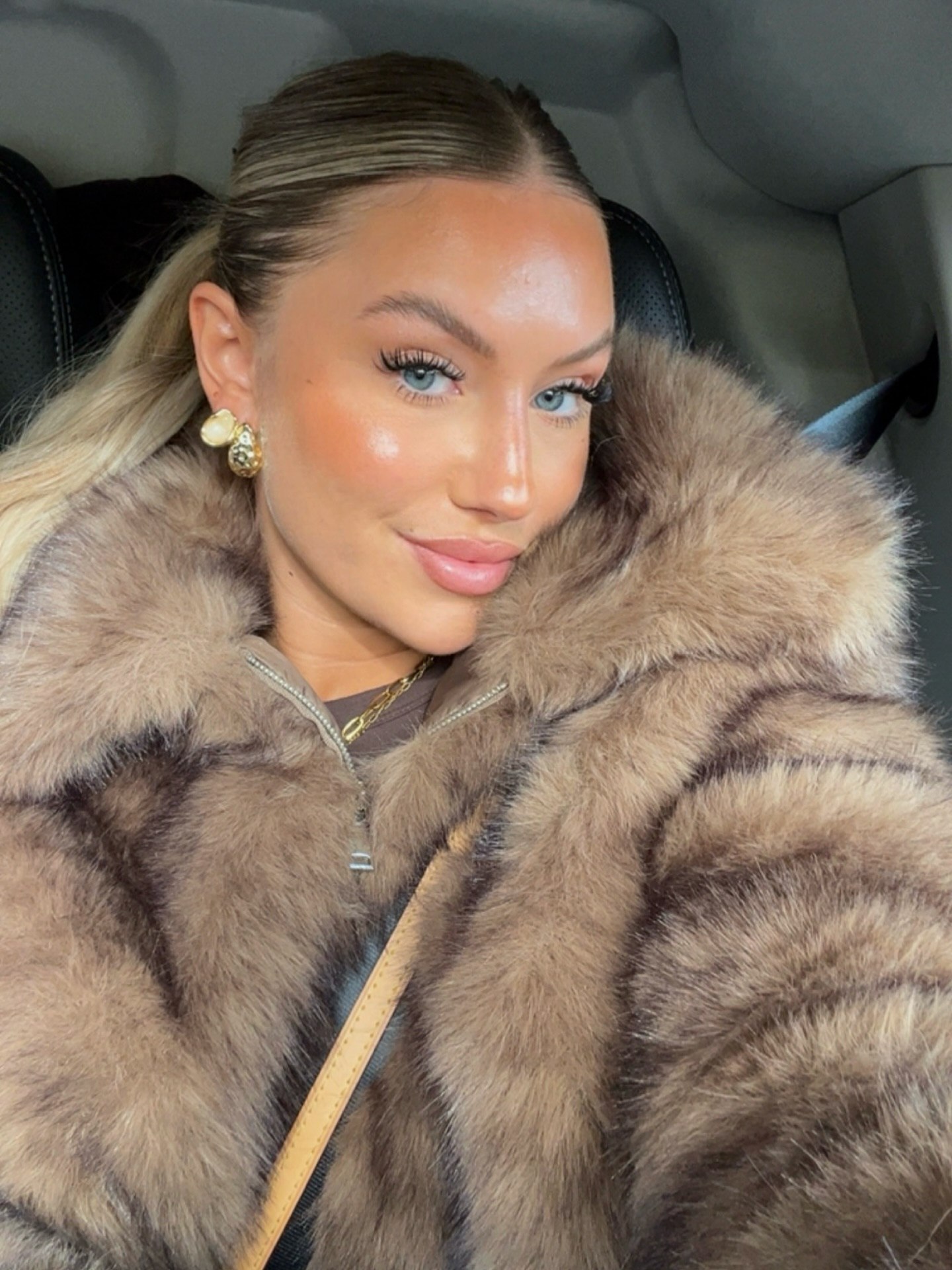 Sleek High Ponytail With Face Framing Tendrils