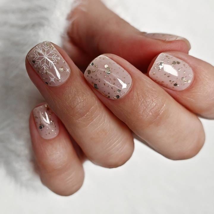 Short Almond Nude Nails With Gold Glitter Snowflakes — Winter Christmas Nails